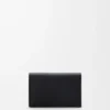 Anagram business cardholder in pebble grained calfskin Black/Gold Anagram business cardholder in pebble grained calfskin Black/Gold