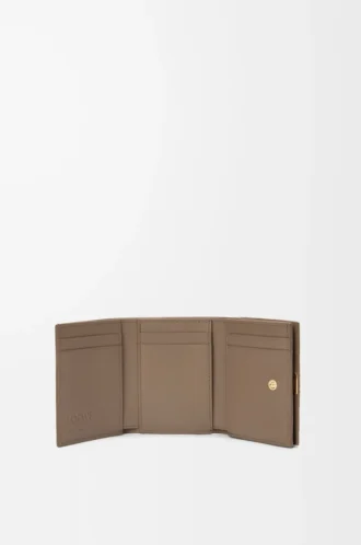 Anagram trifold wallet in pebble grained calfskin Taupe Anagram trifold wallet in pebble grained calfskin Taupe