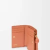 Knot compact wallet in shiny nappa calfskin Tan/Papaya Knot compact wallet in shiny nappa calfskin Tan/Papaya